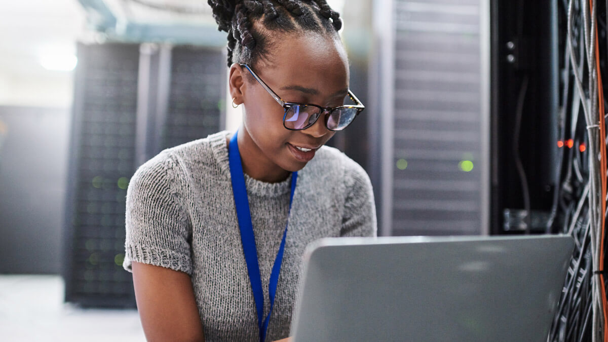 security professional with laptop in a data center