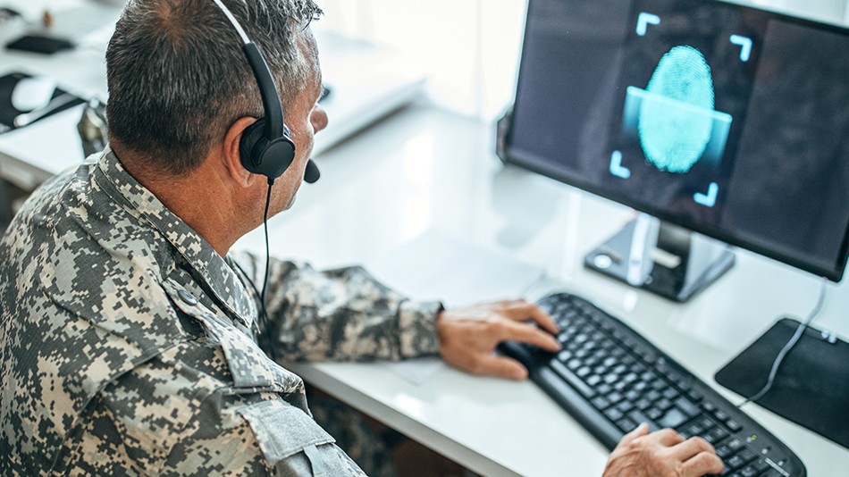 Federal employee scanning their fingerprint for entry to their computer workstation